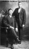 Photo of William Ruben (Standing) and JIm Gareld Miles (Seated)